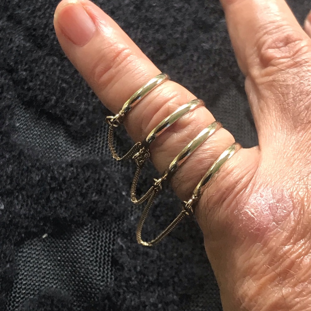 4 rings in one with gold tone chains.